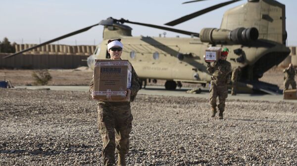 In this file photo, U.S. service members deliver Christmas gifts to their comrades on a base near the al-Omar oilfield in US-occupied eastern Syria. - Sputnik International
