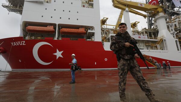 FILE - In this Thursday, June 20, 2019 file photo, a Turkish police officer patrols the dock, backdropped by the drilling ship 'Yavuz' scheduled to be dispatched to the Mediterranean, at the port of Dilovasi, outside Istanbul - Sputnik International