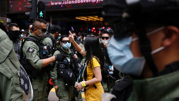A pro-democracy protester argues with police before a protest urging the release of twelve Hong Kong activists, detained on the Chinese mainland, who were arrested at sea after attempting to flee to Taiwan, on Chinese National Day in Hong Kong, China October 1, 2020. - Sputnik International