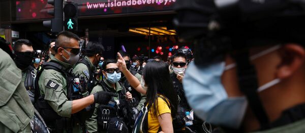 A pro-democracy protester argues with police before a protest urging the release of twelve Hong Kong activists, detained on the Chinese mainland, who were arrested at sea after attempting to flee to Taiwan, on Chinese National Day in Hong Kong, China October 1, 2020. A pro-democracy protester argues with police before a protest urging the release of twelve Hong Kong activists, detained on the Chinese mainland, who were arrested at sea after attempting to flee to Taiwan, on Chinese National Day in Hong Kong, China October 1, 2020. - Sputnik International