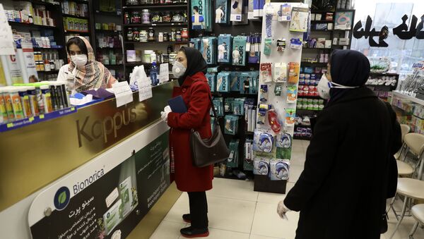 Customers wait as a pharmacist prepares medicines at a pharmacy in western Tehran, Iran, Saturday, Feb. 29, 2020. - Sputnik International