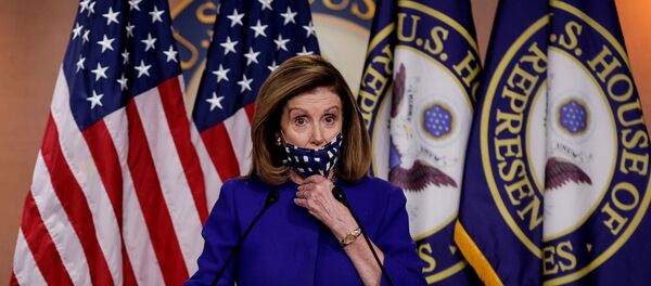 U.S. House Speaker Nancy Pelosi adjusts her face mask as she announces her plans for Congress to create a Commission on Presidential Capacity to Discharge the Powers and Duties of Office Act, after U.S. President Donald Trump came down with coronavirus disease (COVID-19), during a Capitol Hill news conference in Washington, U.S., October 9, 2020. - Sputnik International