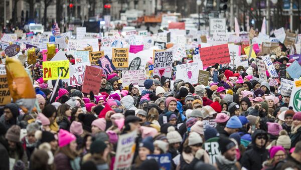 Demonstrators carry signs during the 2020 Women's March on January 18, 2020 in Washington, DC. Marches were held nationwide in cities including New York and Los Angeles.  - Sputnik International