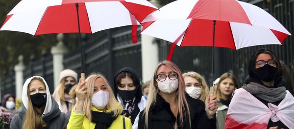 Belarusian women with umbrellas in the colors of the old Belarusian national flag attend an opposition rally to protest the official presidential election results in Minsk, Belarus, Saturday, Oct. 17, 2020. More then one hundred women marched through the Belarusian capital on Saturday to protest against political repressions and demand a new election. Several participants in the rally were detained. Belarusian women with umbrellas in the colors of the old Belarusian national flag attend an opposition rally to protest the official presidential election results in Minsk, Belarus, Saturday, Oct. 17, 2020. More then one hundred women marched through the Belarusian capital on Saturday to protest against political repressions and demand a new election. Several participants in the rally were detained. - Sputnik International