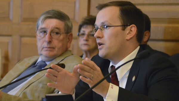In this May 13, 2015 file photo, Kansas state Rep. Brandon Whipple, D-Wichita, speaks at the Statehouse in Topeka, Kan. Whipple, now the Mayor of Wichita and three City Council members have quarantined themselves after being told  Tuesday, March 17, 2020,  that two people at a conference they attended last week have the coronavirus. Whipple and council members Becky Tuttle, James Clendenin and Brandon Johnson attended the National League of Cities conference in Washington D.C. - Sputnik International