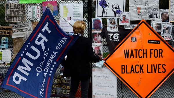 A supporter of US President Donald Trump arrives at Black Lives Matter Plaza in Washington, DC, on 10 October 2020, before a speech by the American President at the White House. - Sputnik International