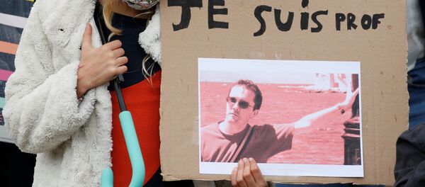 A girl holds a banner with a picture of Samuel Paty, the French teacher who was beheaded on the streets of the Paris suburb of Conflans St Honorine, during a tribute at the Place de la Republique, in Lille, France, 18 October 2020. REUTERS/Pascal Rossignol NO RESALES. NO ARCHIVES. A girl holds a banner with a picture of Samuel Paty, the French teacher who was beheaded on the streets of the Paris suburb of Conflans St Honorine, during a tribute at the Place de la Republique, in Lille, France, 18 October 2020. REUTERS/Pascal Rossignol NO RESALES. NO ARCHIVES. - Sputnik International