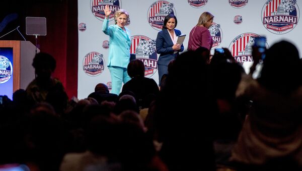 Democrat presidential candidate Hillary Clinton, left, accompanied by NBC reporter Kristen Welker, center, and Telemundo reporter Lori Montenegro, waves as she leaves after speaking at the 2016 National Association of Black Journalists' and National Association of Hispanic Journalists' Hall of Fame Luncheon at Marriott Wardman Park in Washington, Friday, 5 August 2016. - Sputnik International