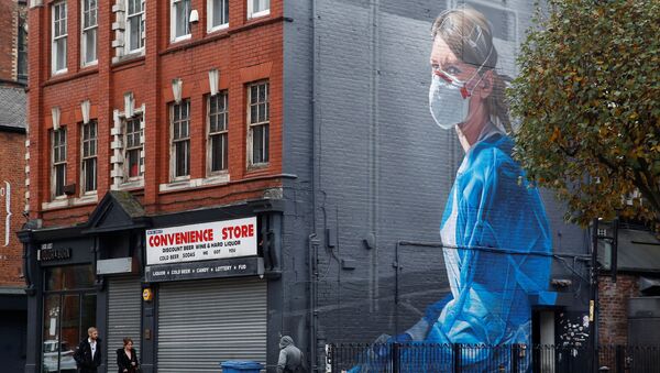 People walk past a mural, as the coronavirus disease (COVID-19) outbreak continues, in Manchester, Britain October 19, 2020 - Sputnik International