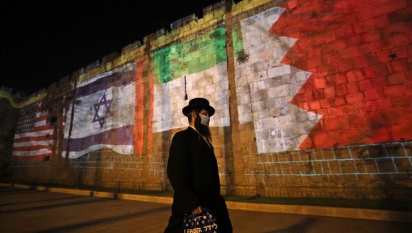 The flags of US, Israel, United Arab Emirates, and Bahrain are projected on the ramparts of Jerusalem's Old City on September 15, 2020 in a show of support for Israeli normalisation deals with the United Arab Emirates and Bahrain. - Sputnik International