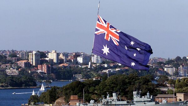 An Australian Navy helicopter hangs a large flag over the HM Bark Endeavour, a full scale replica of Captain James Cook's original 18th century ship, as she sails into Sydney Harbour 03 June 2000 - Sputnik International