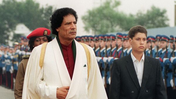 Libyan Head of State Colonel Muammar Gaddafi (L) and his son Saif al-Islam Gaddafi review troops 3 September 1989 upon their arrival in Belgrade before the Non-Aligned Summit. - Sputnik International