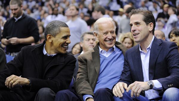 This Jan. 30, 2010 file photo shows Hunter Biden, right, son of Vice President Joe Biden, center, talking with President Barack Obama, and the vice president Joe Biden during a college basketball game in Washington.  Biden's youngest son Hunter is joining the Navy. The Navy says the attorney and former Washington lobbyist was selected to be commissioned into the Navy Reserve as a public affairs officer. Because he is 42, he needed a special waiver to be accepted, but that is not uncommon. He is one of seven candidates recommended for a direct commission for public affairs.  - Sputnik International