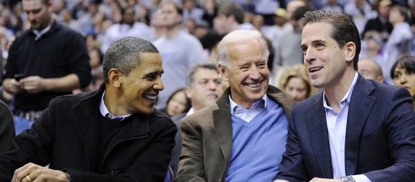 This Jan. 30, 2010 file photo shows Hunter Biden, right, son of Vice President Joe Biden, center, talking with President Barack Obama, and the vice president Joe Biden during a college basketball game in Washington.  Biden's youngest son Hunter is joining the Navy. The Navy says the attorney and former Washington lobbyist was selected to be commissioned into the Navy Reserve as a public affairs officer. Because he is 42, he needed a special waiver to be accepted, but that is not uncommon. He is one of seven candidates recommended for a direct commission for public affairs.  - Sputnik International