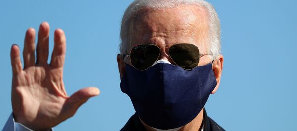 US Democratic presidential candidate Joe Biden waves to journalists before boarding his campaign plane ahead of a trip to North Carolina, at the New Castle County Airport in New Castle, Delaware, US, October 18, 2020 US Democratic presidential candidate Joe Biden waves to journalists before boarding his campaign plane ahead of a trip to North Carolina, at the New Castle County Airport in New Castle, Delaware, US, October 18, 2020 - Sputnik International