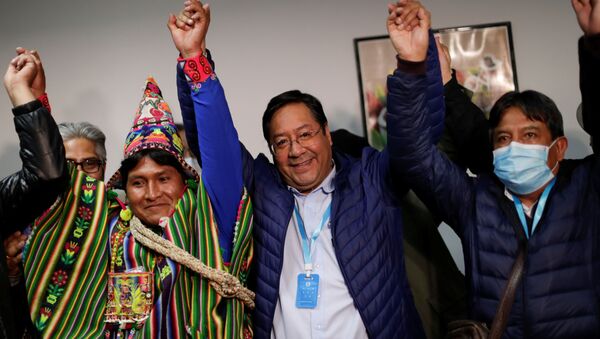 Presidential candidate Luis Arce of the Movement for Socialism party (MAS) rejoices next to vice-presidential candidate David Choquehuanca, who wears a protective face mask, after addressing the media during the presidential election in La Paz, Bolivia, 19 October 2020. - Sputnik International