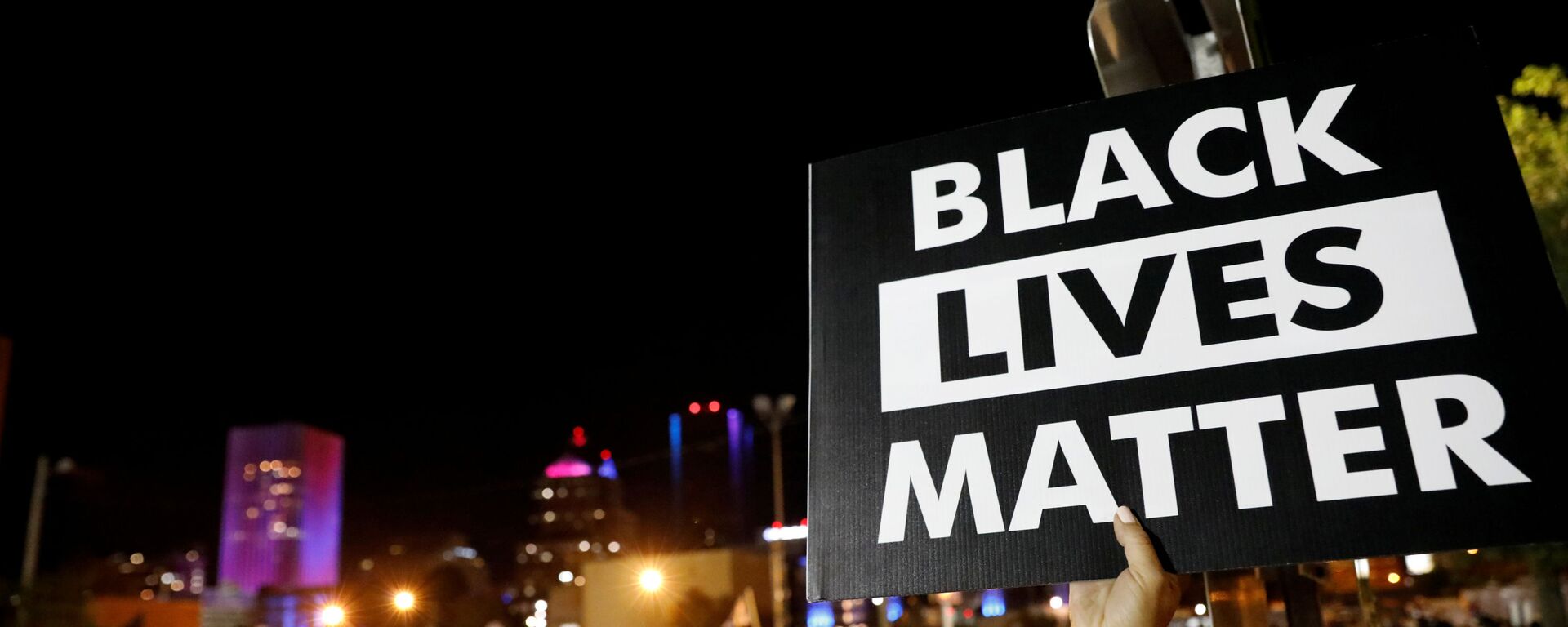 A demonstrator holds up a Black Lives Matter sign during a protest over the death of Daniel Prude after police put a spit hood over his head during an arrest on 23 March, in Rochester, New York, 6 September 2020 - Sputnik International, 1920, 23.12.2020