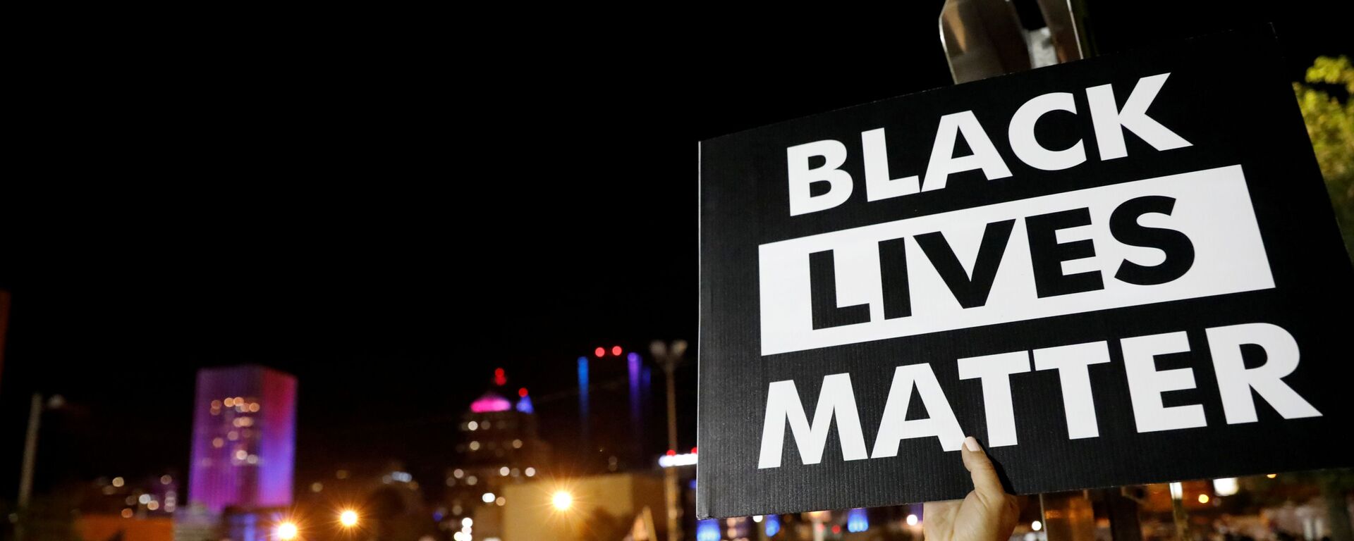 A demonstrator holds up a Black Lives Matter sign during a protest over the death of a Black man, Daniel Prude, after police put a spit hood over his head during an arrest on March 23, in Rochester, New York, U.S. September 6, 2020 - Sputnik International, 1920, 01.06.2021