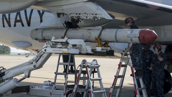Aviation Ordnanceman 3rd Class Michael Martin, left,, and Aviation Ordnanceman Airman Cecilia Duran, both assigned to the Pro's Nest of Patrol Squadron (VP) 30, load an AGM-84K SLAM-ER missile on a P-8A Poseidon in preparation for a conventional weapons technical proficiency inspection. - Sputnik International