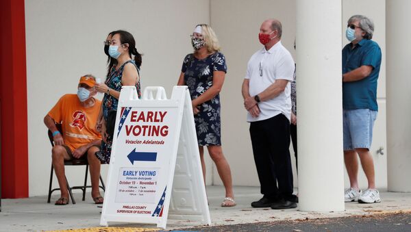 People line up at the Supervisor of Elections Office polling station as early voting begins in Pinellas County ahead of the election in Largo, Florida, U.S. October 21, 2020 - Sputnik International