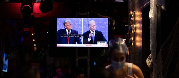 People watch the second 2020 presidential campaign debate between Democratic presidential nominee Joe Biden and U.S. President Donald Trump at The Abbey Bar during the outbreak of the coronavirus disease (COVID-19), in West Hollywood, California, U.S., October 22, 2020. People watch the second 2020 presidential campaign debate between Democratic presidential nominee Joe Biden and U.S. President Donald Trump at The Abbey Bar during the outbreak of the coronavirus disease (COVID-19), in West Hollywood, California, U.S., October 22, 2020. - Sputnik International
