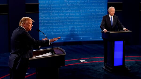 U.S. President Donald Trump answers a question as Democratic presidential candidate former Vice President Joe Biden listens during the final presidential debate at the Curb Event Center at Belmont University in Nashville, Tennessee, U.S - Sputnik International