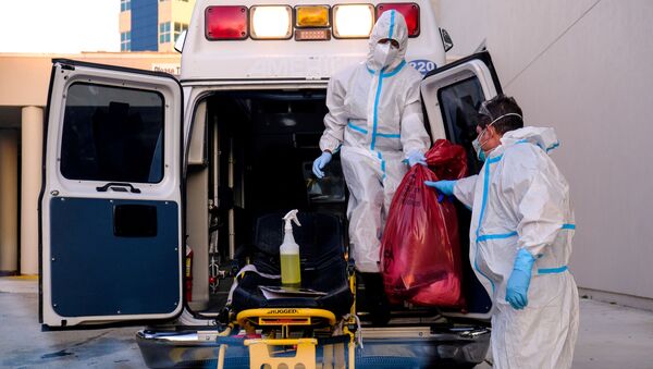 EMTs cleanse their materials outside Memorial West Hospital where coronavirus disease (COVID-19) patients are treated, in Pembroke Pines, Florida, U.S. July 13, 2020.  - Sputnik International