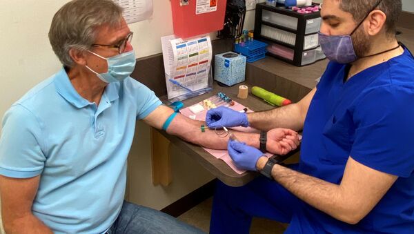 Atlanta resident Norman Hulme, 65, prepares to have his blood drawn as part of a Phase 1 clinical trial for a coronavirus disease (COVID-19) vaccine mRNA-1273 at Emory University’s Hope Clinic in Atlanta, Georgia, U.S. May 4, 2020. - Sputnik International