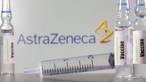  A test tube labelled vaccine is seen in front of AstraZeneca logo in this illustration taken, September 9, 2020. - Sputnik International