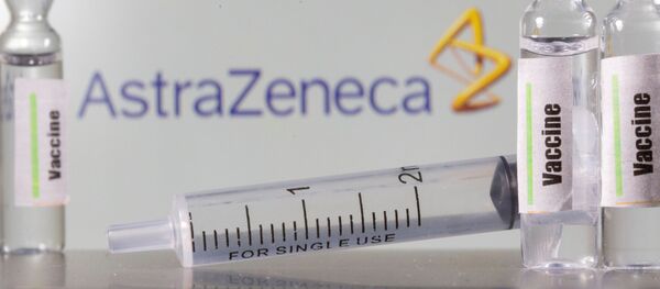  A test tube labelled vaccine is seen in front of AstraZeneca logo in this illustration taken, September 9, 2020. - Sputnik International