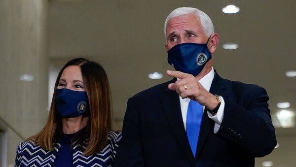 U.S. Vice President Mike Pence, stands with his wife, Karen, after casting his ballot for the upcoming election at a polling station in Indianapolis, Indiana, U.S. October 23, 2020. - Sputnik International