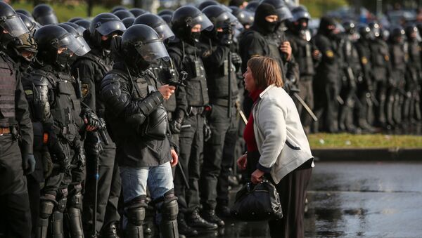 An opposition supporter argues with a police officer during an opposition rally to reject the presidential election results in Minsk, Belarus October 4, 2020.  - Sputnik International