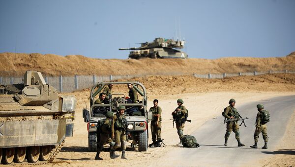 Israeli soldiers stand near a military jeep and an armoured personnel carrier (APC) close to the site where Israel discovered a new cross-border tunnel from the Gaza Strip that its military said extended dozens of metres underground and into southern Israel, along the border with the Gaza Strip, southern Israel October 21, 2020. REUTERS/Amir Cohen - Sputnik International