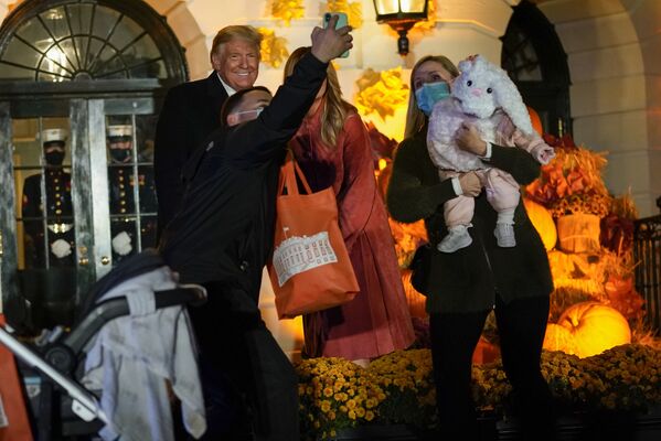 President Donald Trump and first lady Melania greet trick-or-treaters on the South Lawn during a Halloween celebration on 25 October 2020 in Washington.  - Sputnik International