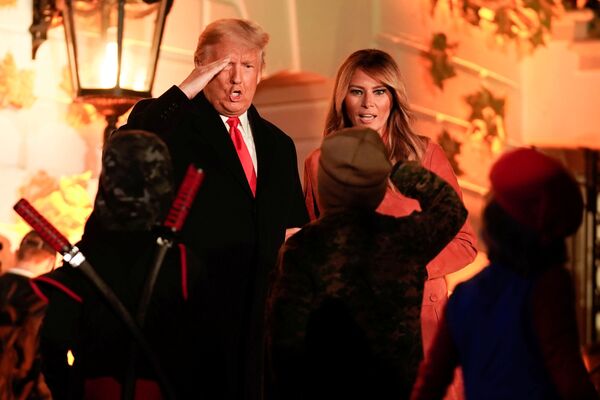 US President Donald Trump salutes children in costume as he and first lady Melania Trump host a Halloween event at the White House on 25 October 2020.  - Sputnik International