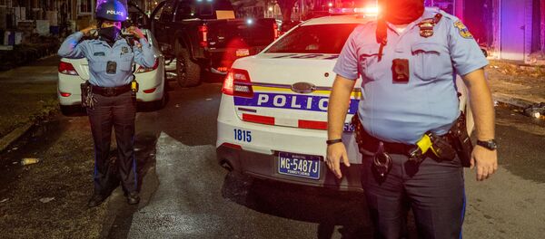 Police officers guard a pick-up truck loaded with looted merchandise following protests over the police shooting death of Walter Wallace in Philadelphia, Pennsylvania, U.S., October 27, 2020. - Sputnik International