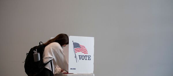 People cast their ballots for the upcoming presidential elections as early voting begins in Ann Arbor, Michigan, U.S., September 24, 2020. - Sputnik International