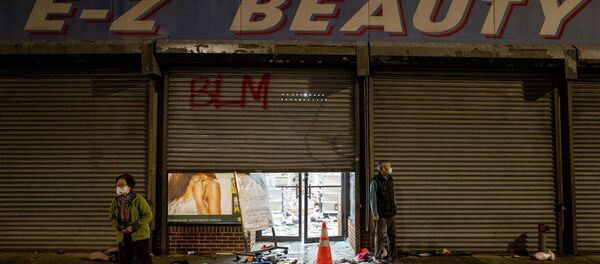 A business owner stands outside of her looted beauty supply store following protests over the police shooting death of Walter Wallace in Philadelphia, Pennsylvania, U.S., October 27, 2020. - Sputnik International