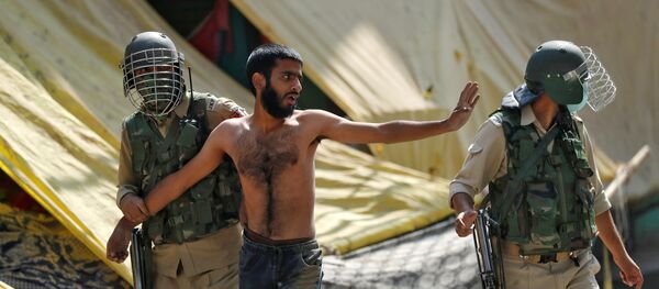 A man gestures after he was detained by Indian policemen during a protest near the site of a gun battle between Indian security forces and suspected militants, in Srinagar, 12 October 2020. A man gestures after he was detained by Indian policemen during a protest near the site of a gun battle between Indian security forces and suspected militants, in Srinagar, 12 October 2020. - Sputnik International