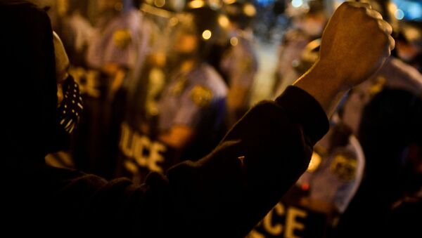 A demonstrator raises his fist during a rally after the death of Walter Wallace Jr., a Black man who was shot by police in Philadelphia, Pennsylvania, U.S., October 27, 2020. - Sputnik International