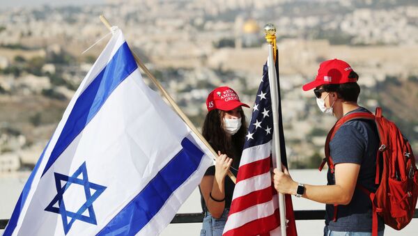 Activists hold American and Israeli flags after joining a convoy to the U.S. Embassy in Jerusalem to show support for U.S. President Donald Trump, ahead of the upcoming U.S. election, in Jerusalem October 27, 2020.  - Sputnik International