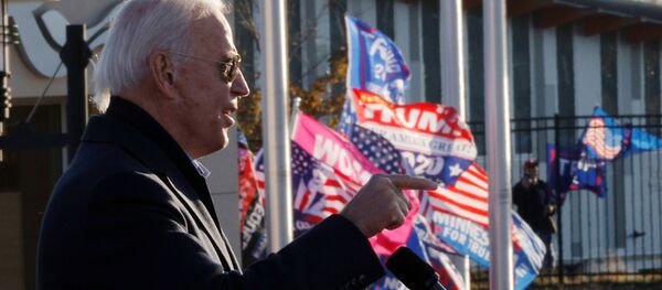 Democratic U.S. presidential nominee and former Vice President Joe Biden speaks as supporters of U.S. President Donald Trump hold up flags and posters nearby, during a drive-in campaign stop in St. Paul, Minnesota, U.S., October 30, 2020.  - Sputnik International