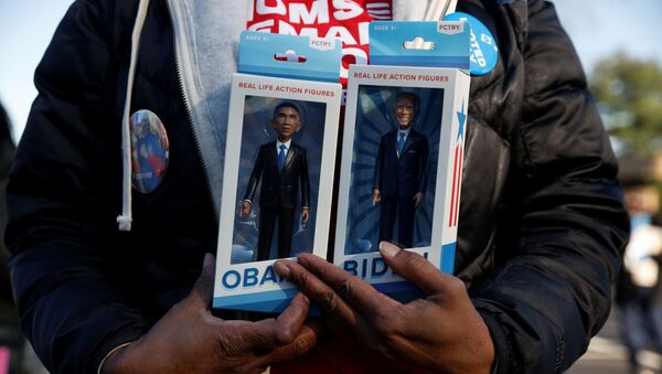 A person holds real life action figures depicting democratic U.S. presidential nominee and former Vice President Joe Biden and former U.S. President Barack Obama during a campaign canvas kickoff in Bloomfield Hills, Michigan, U.S., October 31, 2020. - Sputnik International