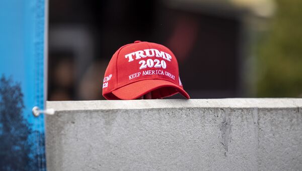 A supporter of President Trump set down a hat supporting his reelection during a speech by Democratic presidential candidate U.S. Sen. Kirsten Gillibrand (D-NY) at the Iowa State Fair on August 10, 2019 in Des Moines, Iowa. - Sputnik International