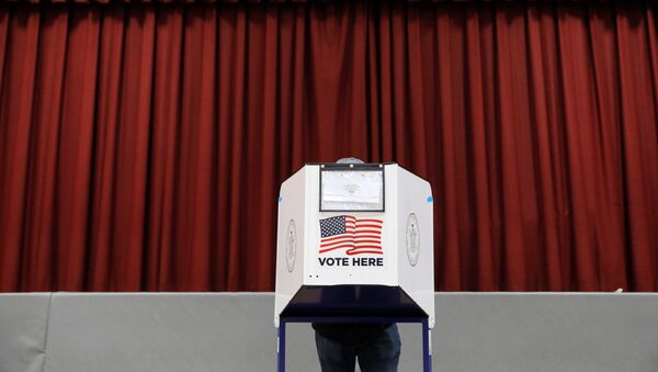 A person fills out a ballot in a privacy booth at a polling station located in the Monsignor John D. Burke Memorial Gym at the Church of the Holy Child in Staten Island, during early voting in New York City, U.S., October 25, 2020. - Sputnik International