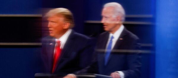 FILE PHOTO: U.S. President Donald Trump and Democratic presidential nominee Joe Biden are reflected in the plexiglass protecting a tv camera operator from covid as they participate in their second 2020 presidential campaign debate at Belmont University in Nashville, Tennessee, U.S., October 22, 2020 FILE PHOTO: U.S. President Donald Trump and Democratic presidential nominee Joe Biden are reflected in the plexiglass protecting a tv camera operator from covid as they participate in their second 2020 presidential campaign debate at Belmont University in Nashville, Tennessee, U.S., October 22, 2020 - Sputnik International
