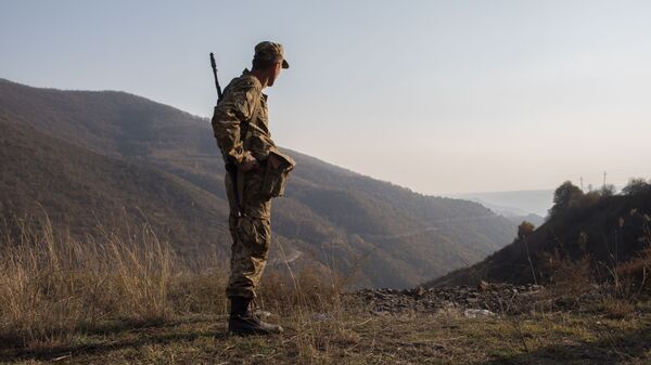 An armed man is pictured in the area of the Lachin corridor, the self-proclaimed Nagorno-Karabakh Republic - Sputnik International