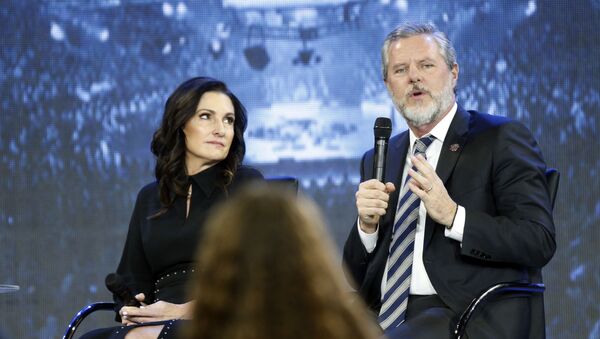 In this Wednesday, Nov. 28, 2018 file photo, Jerry Falwell Jr., right, answers a student's question, accompanied by his wife, Becki, during a town hall meeting on the opioid crisis at a convocation at Liberty University in Lynchburg, Va. On Aug. 7, 2020, Falwell stepped down, at least temporarily, from his role as the president of the school. - Sputnik International