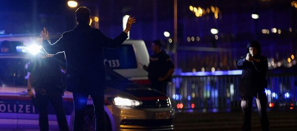 Police officers check a man on a street after exchanges of gunfire in Vienna, Austria November 2, 2020 - Sputnik International