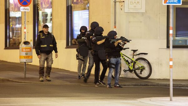 Police officers aim their weapons on the corner of a street after exchanges of gunfire in Vienna, Austria November 2, 2020 - Sputnik International